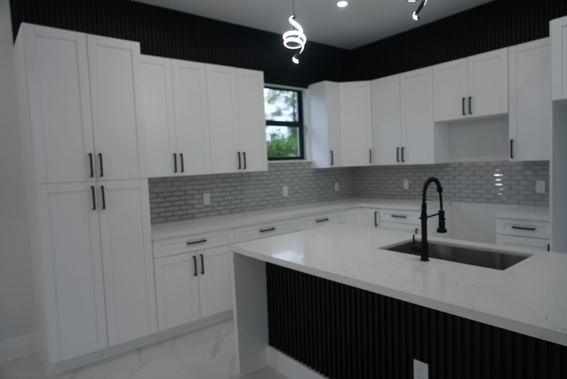 Modern white kitchen with black island